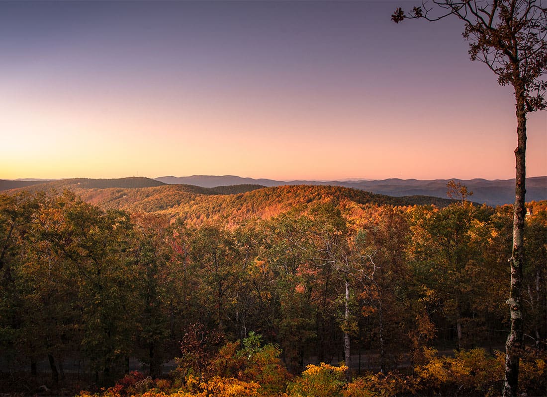 Jasper GA Insurance - Dramatic Sunset Behind Hills and Trees in Jasper Georgia